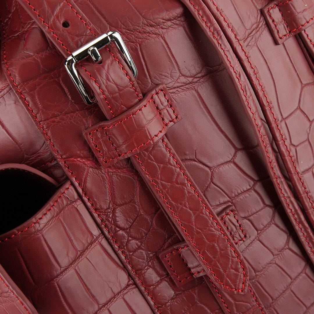 Rossie Viren crocodile leather backpack in wine red, featuring a textured crocodile pattern and sturdy leather straps.