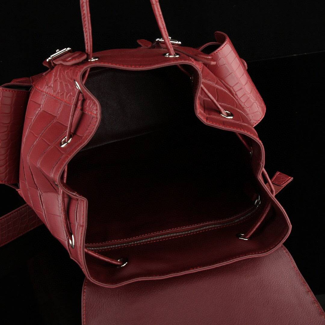Rossie Viren crocodile leather backpack in wine red, showcasing textured crocodile pattern and adjustable shoulder straps.