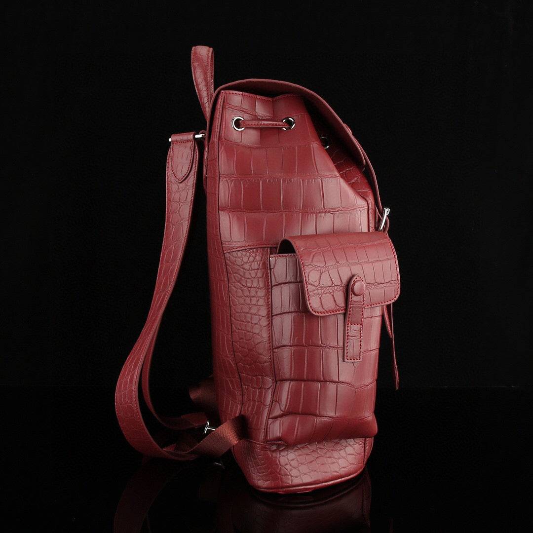 Rossie Viren crocodile leather backpack in wine red with textured crocodile skin and adjustable shoulder straps.
