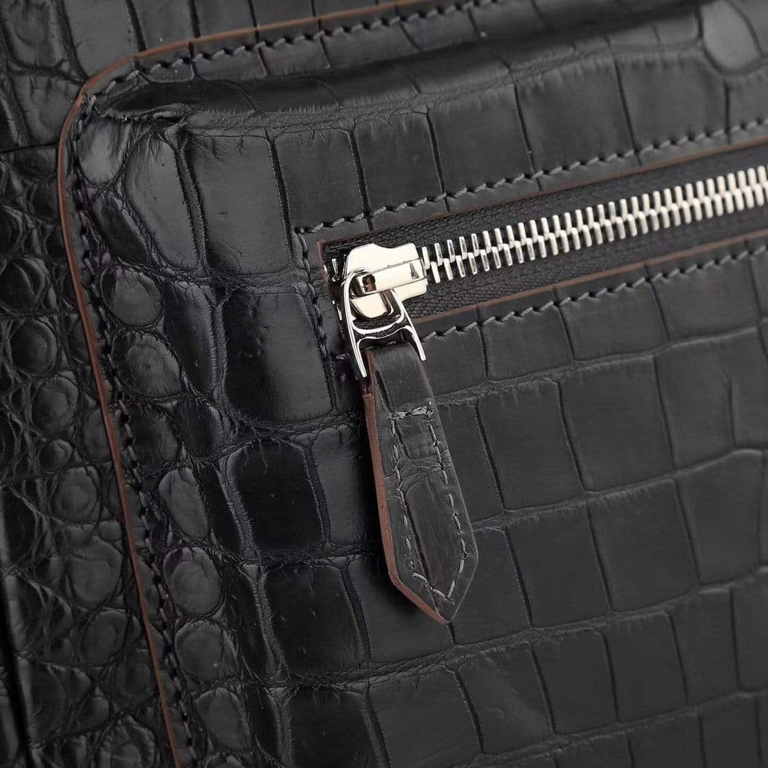 Black crocodile leather handbag for women with adjustable straps and silver hardware by Rossie Viren.