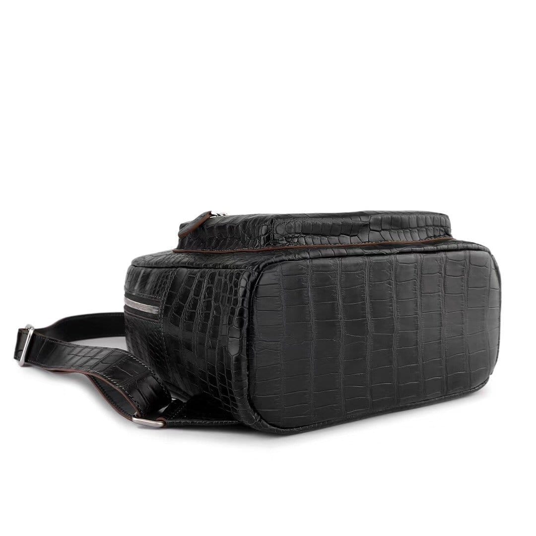 Black crocodile leather handbag for women by Rossie Viren, stylish backpack with textured crocodile pattern and adjustable straps.