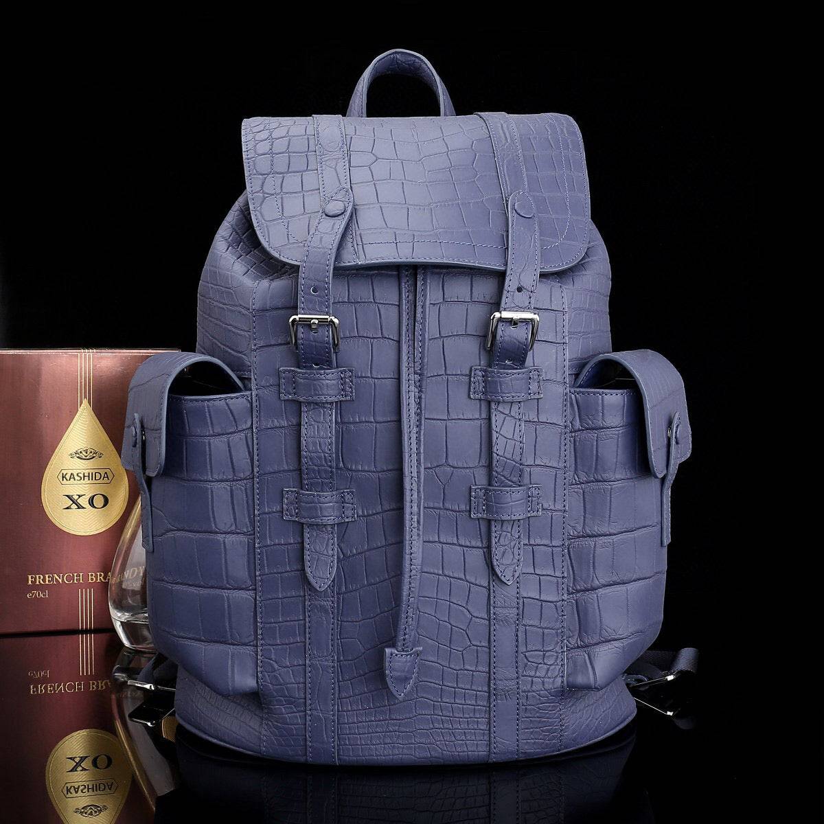 Dark blue crocodile leather backpack by Rossie Viren, featuring a textured crocodile pattern and adjustable shoulder straps.