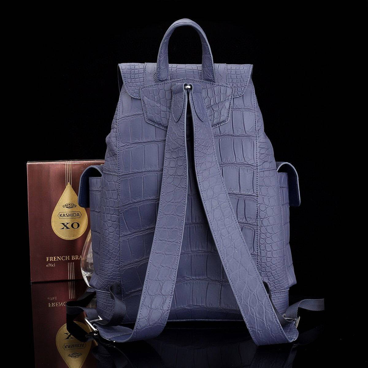 Dark blue crocodile leather backpack by Rossie Viren, featuring a textured surface, sturdy straps, and a spacious main compartment.