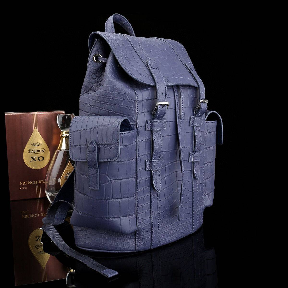 Dark blue crocodile leather backpack by Rossie Viren, featuring a textured crocodile pattern and sturdy leather straps.