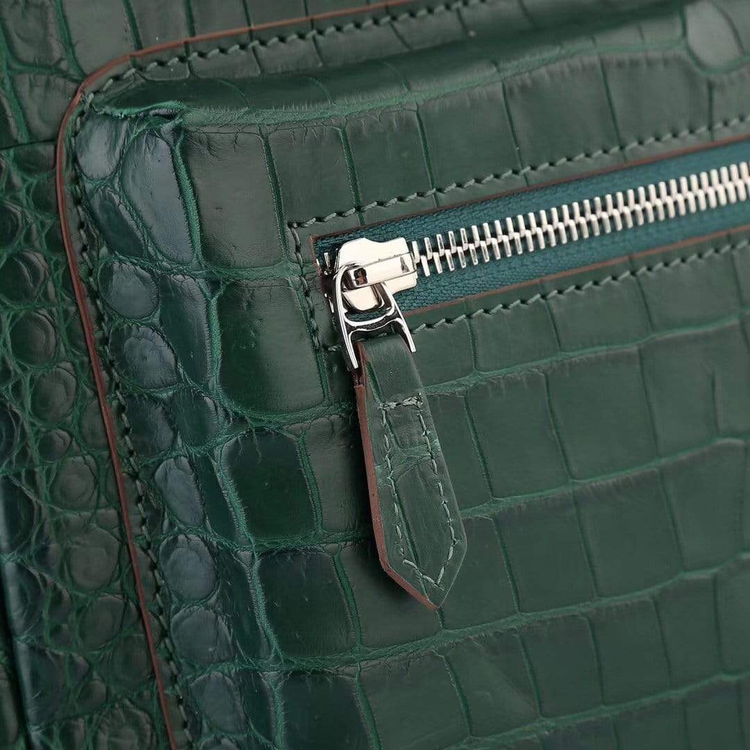 Dark green crocodile leather handbag for women by Rossie Viren, featuring a stylish and textured backpack design.