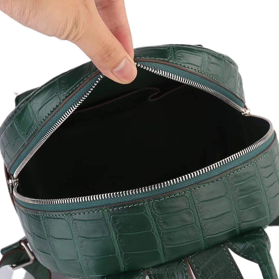 Dark green crocodile leather handbag for women by Rossie Viren, stylish backpack with textured crocodile pattern and adjustable straps.