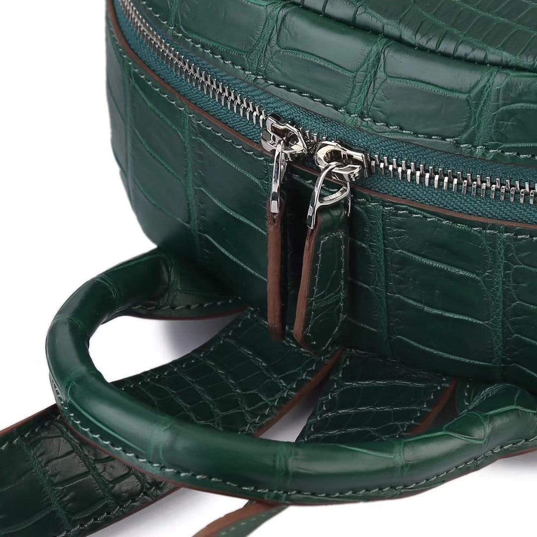 Dark green crocodile leather backpack for women by Rossie Viren, featuring a stylish handbag design with textured leather details.