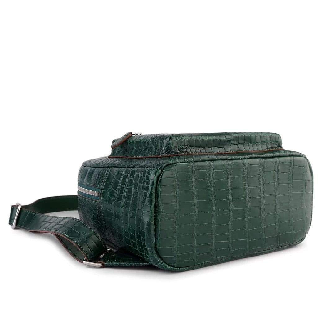 Dark green crocodile leather women's backpack handbag by Rossie Viren with sleek design and top handle.