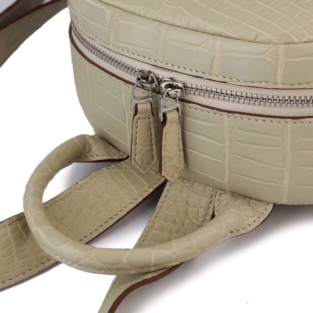 Cream crocodile leather handbag for women by Rossie Viren, stylish backpack with textured crocodile pattern and top handle.