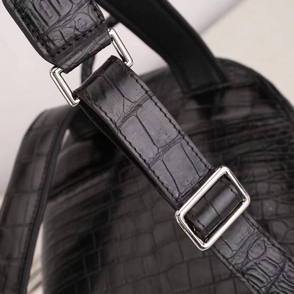 Crocodile leather women's backpack by Rossie Viren featuring a sleek design with adjustable straps and gold-tone hardware.