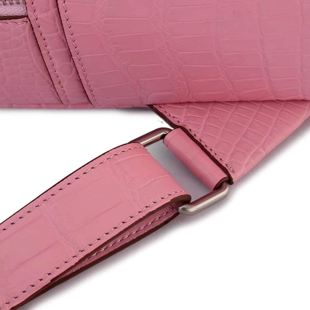 Pink crocodile leather handbag for women by Rossie Viren, stylish backpack with textured crocodile pattern and adjustable straps.