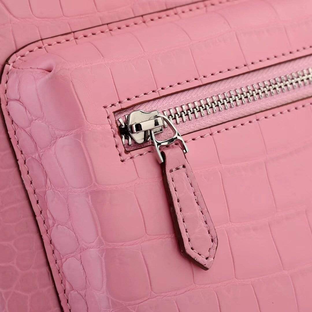 Pink crocodile leather handbag for women by Rossie Viren, featuring a stylish and textured backpack design.