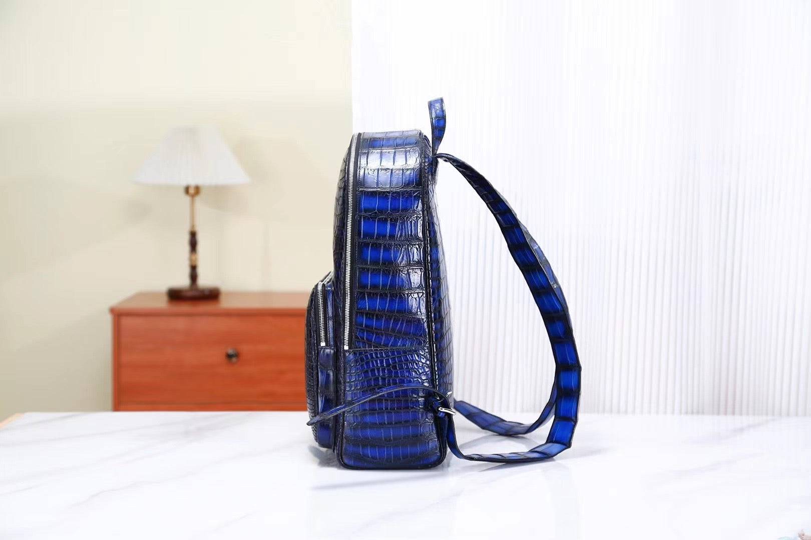 Vintage blue crocodile leather backpack handbag by Rossie Viren with textured crocodile pattern and adjustable straps.