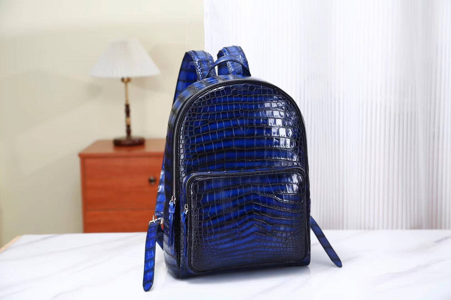 Vintage blue crocodile leather backpack handbag by Rossie Viren showing textured crocodile pattern and adjustable shoulder straps.