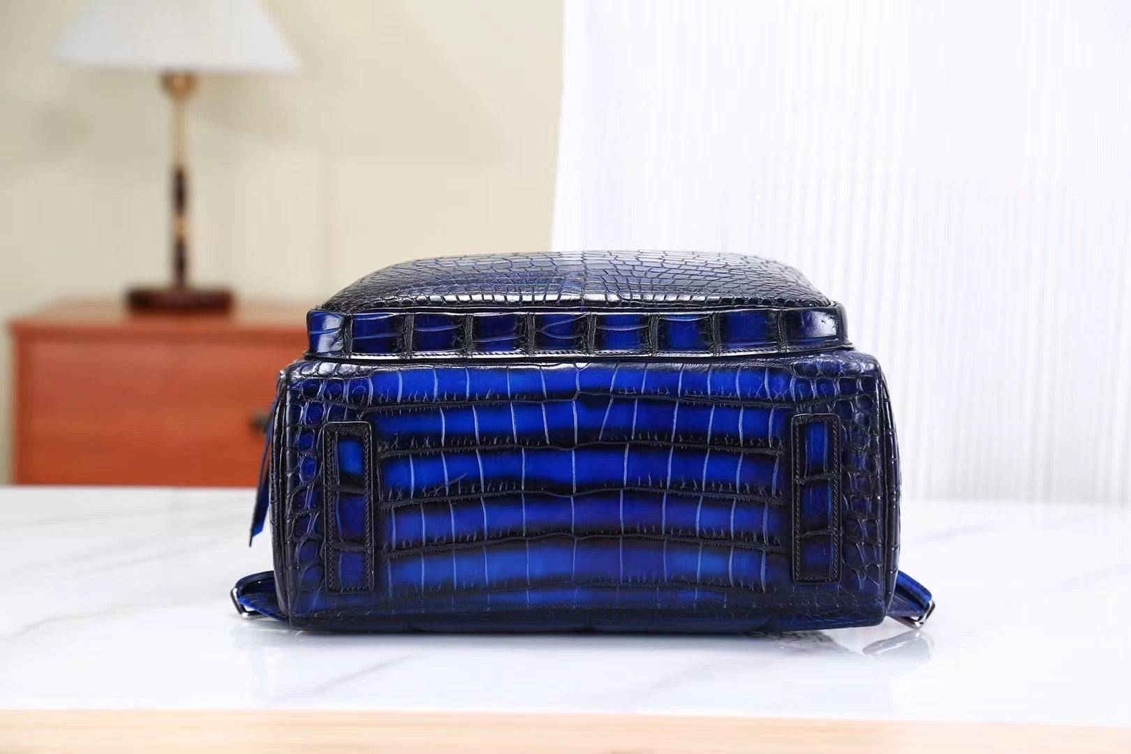 Vintage blue crocodile leather backpack handbag by Rossie Viren, featuring a textured crocodile pattern and adjustable straps.