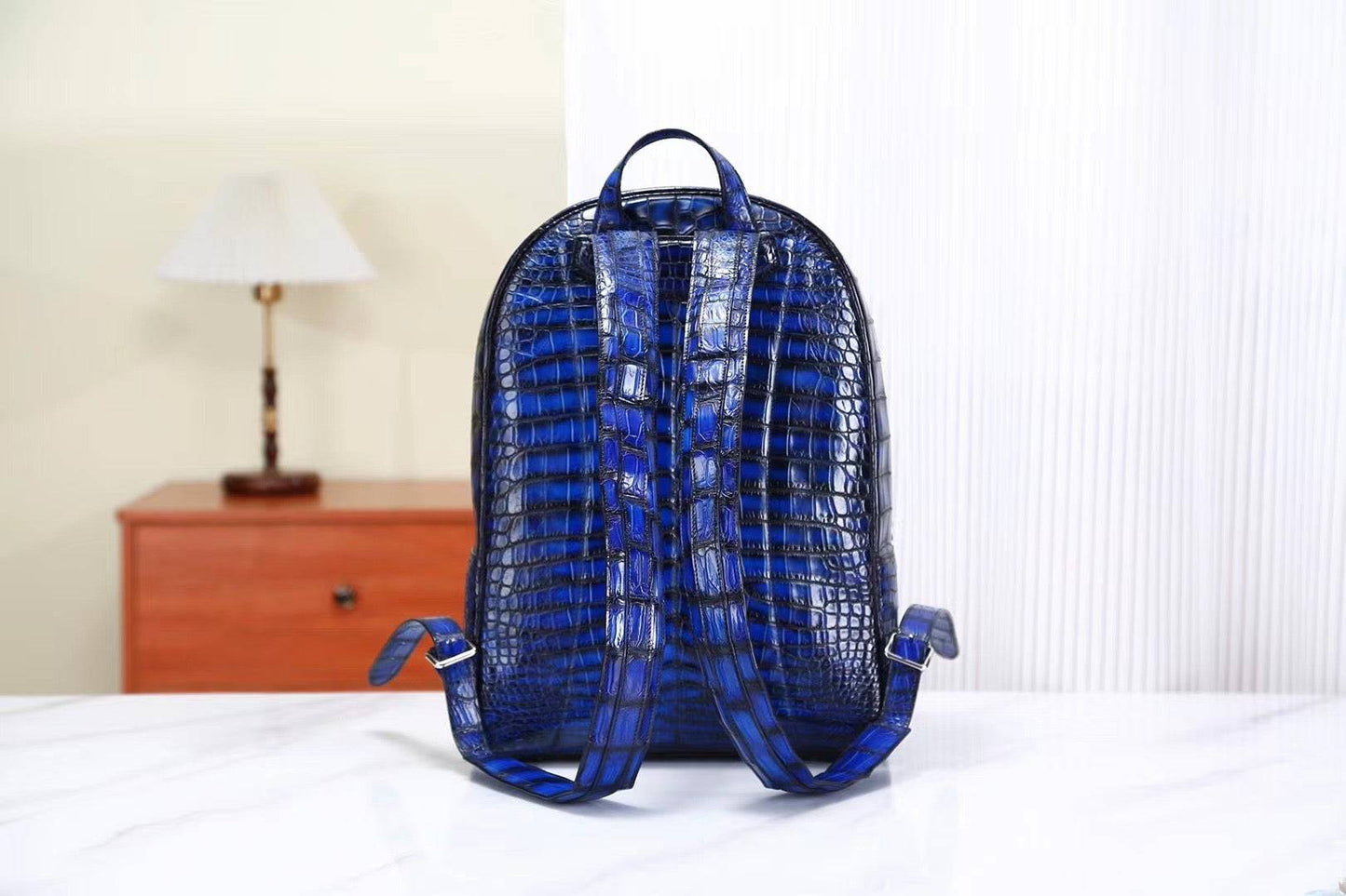 Vintage blue crocodile leather backpack handbag by Rossie Viren, showing textured crocodile pattern and adjustable straps.