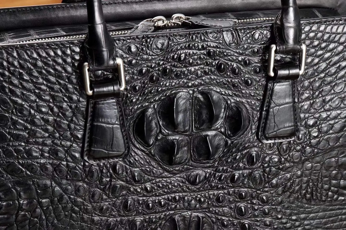 Rossie Viren crocodile leather briefcase handbag with sleek design and sturdy handles, showcasing luxurious textured crocodile pattern.