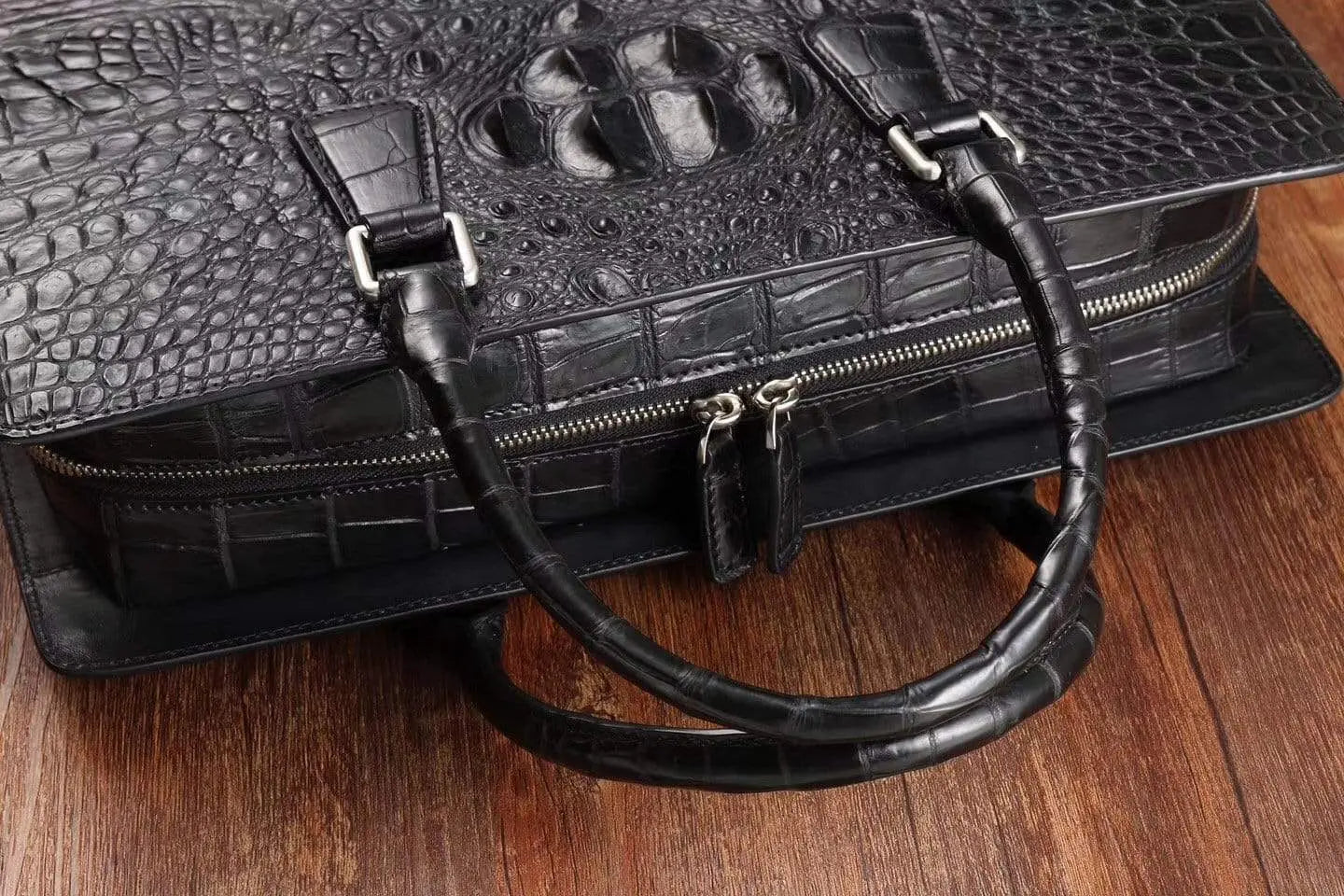 Rossie Viren crocodile leather briefcase handbag with sleek design and sturdy handles, showcasing luxurious textured crocodile pattern.