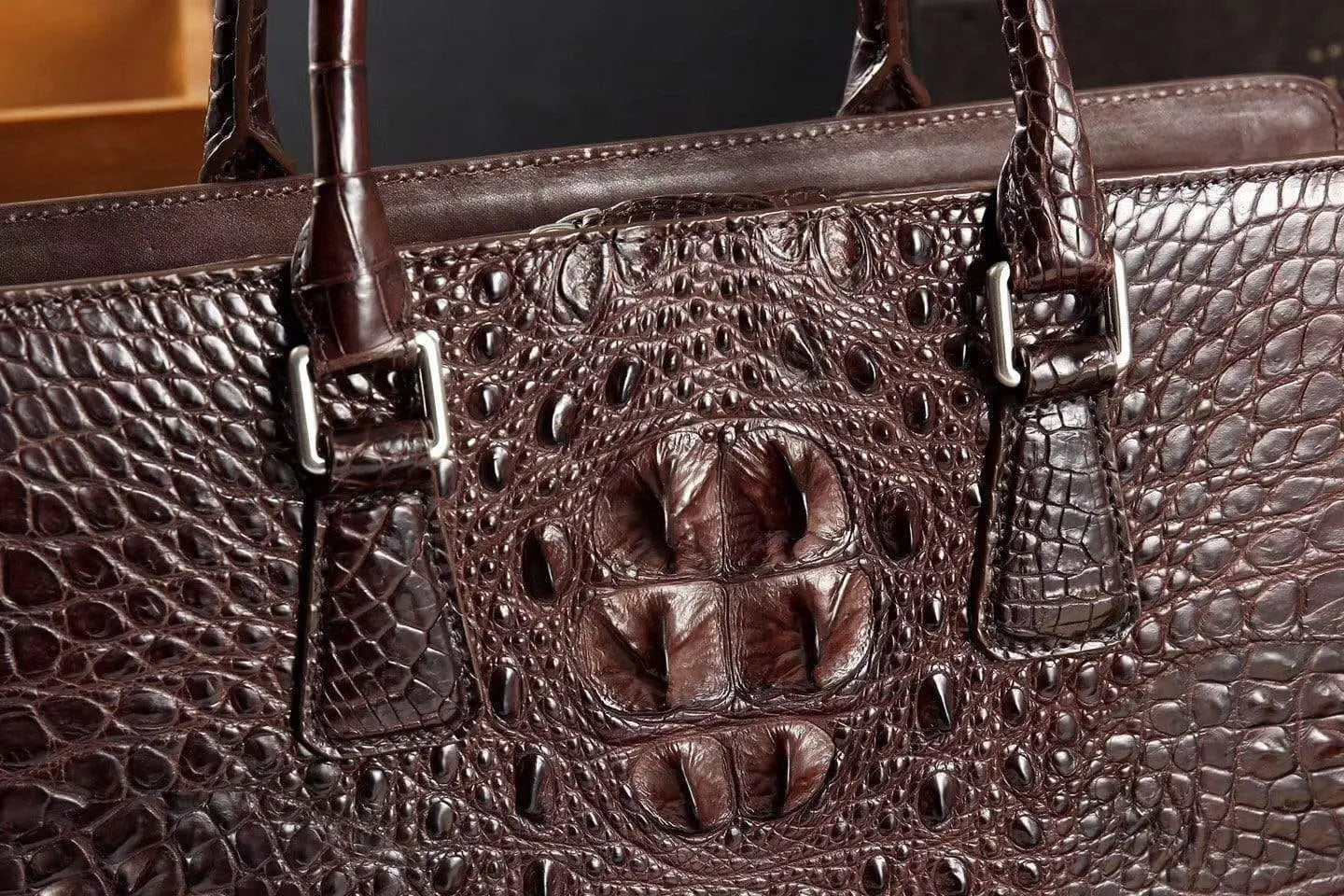 Rossie Viren crocodile leather briefcase handbag with sleek design and sturdy handle, showcasing luxurious texture.