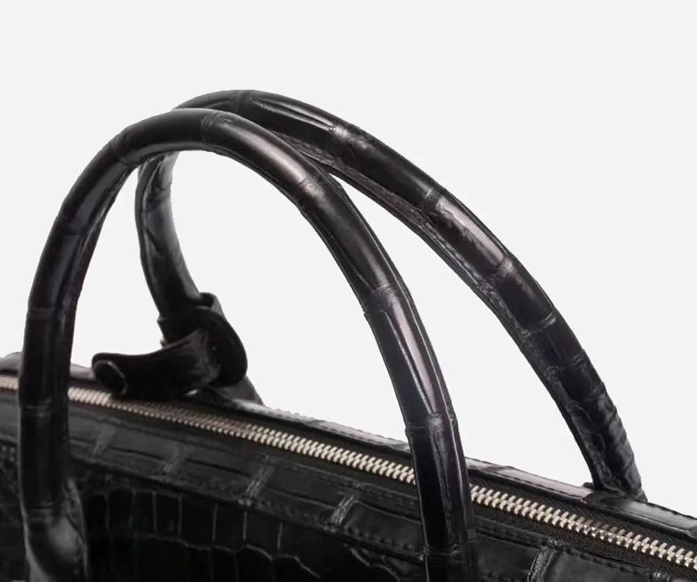Crocodile leather briefcase for men with shoulder strap, password lock, and compartments for laptops and business documents.