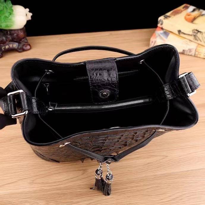 Crocodile leather bucket handbag for women by Rossie Viren with drawstring closure, crossbody strap, and tote style.