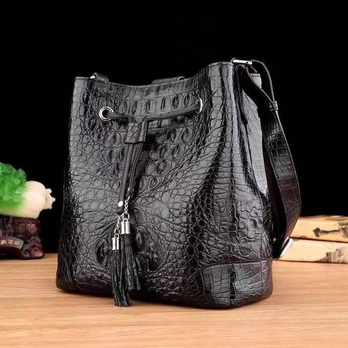 Crocodile leather bucket handbag for women by Rossie Viren, with drawstring closure, crossbody strap, and tote style design.