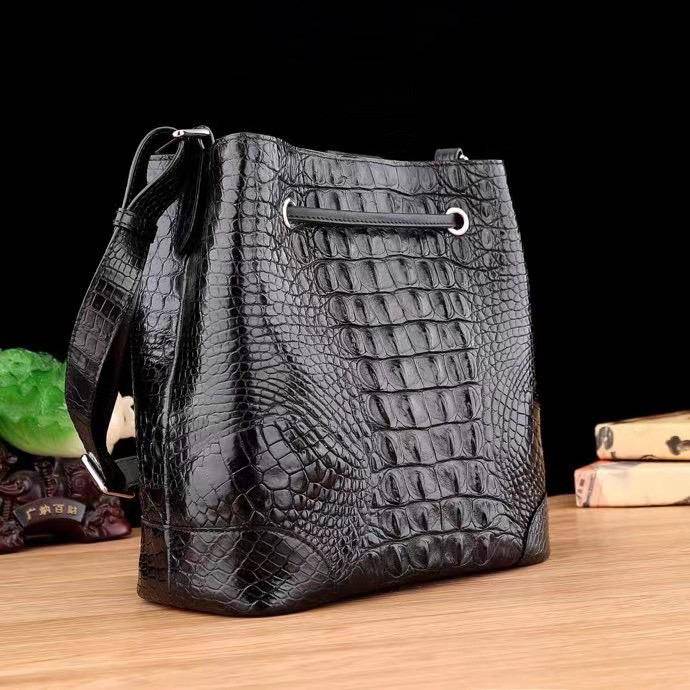 Crocodile leather bucket handbag for women by Rossie Viren with drawstring closure, crossbody strap, and tote handle.