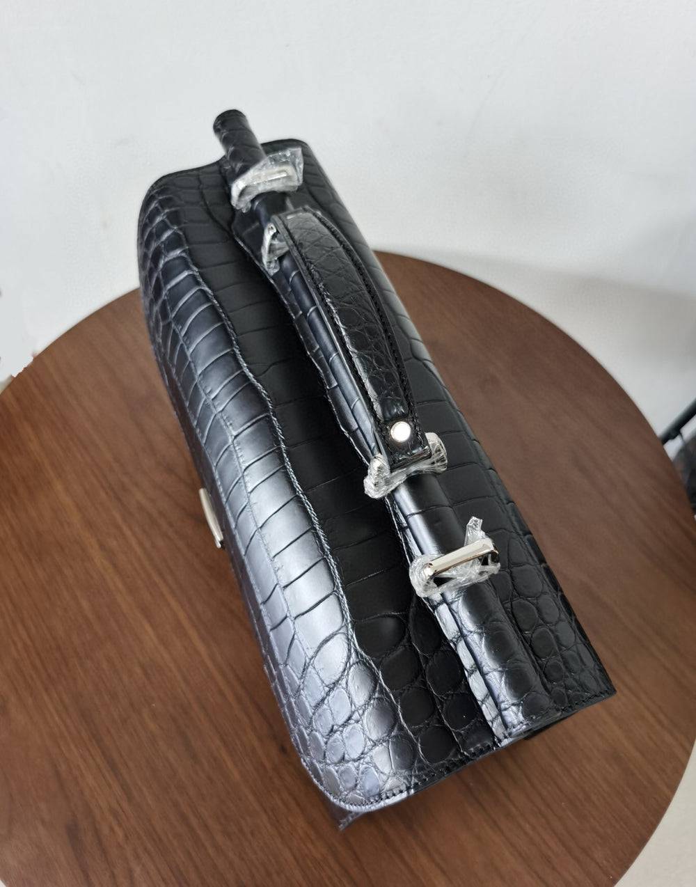Black crocodile leather Rossie Viren business briefcase with sturdy handles and sleek design for professional use.