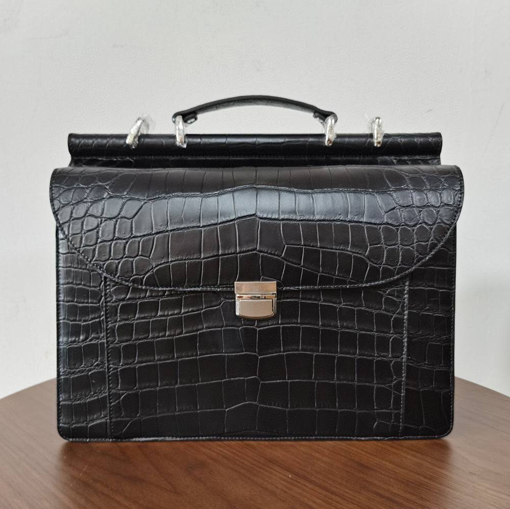 Black crocodile leather business briefcase by Rossie Viren, featuring a structured handbag design with sturdy handles and sleek finish.