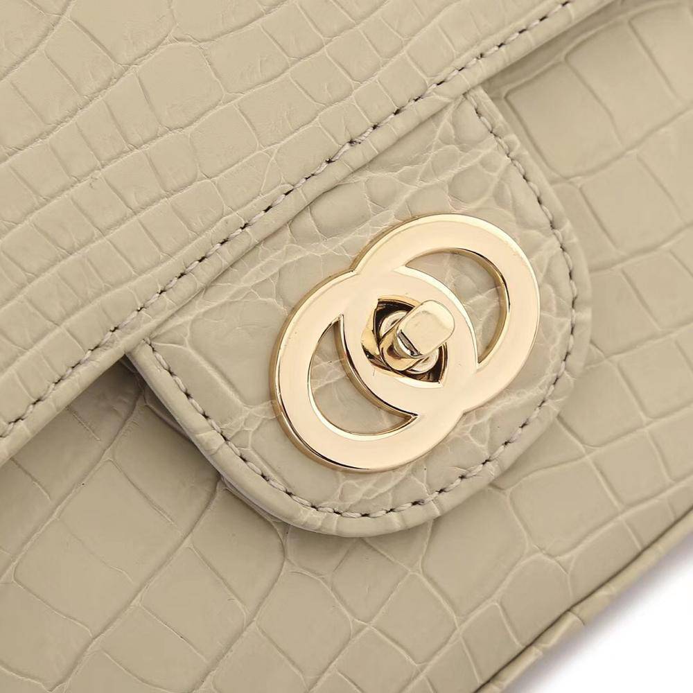 Beige crocodile leather shoulder handbag with classic flap and chain strap by Rossie Viren for women.