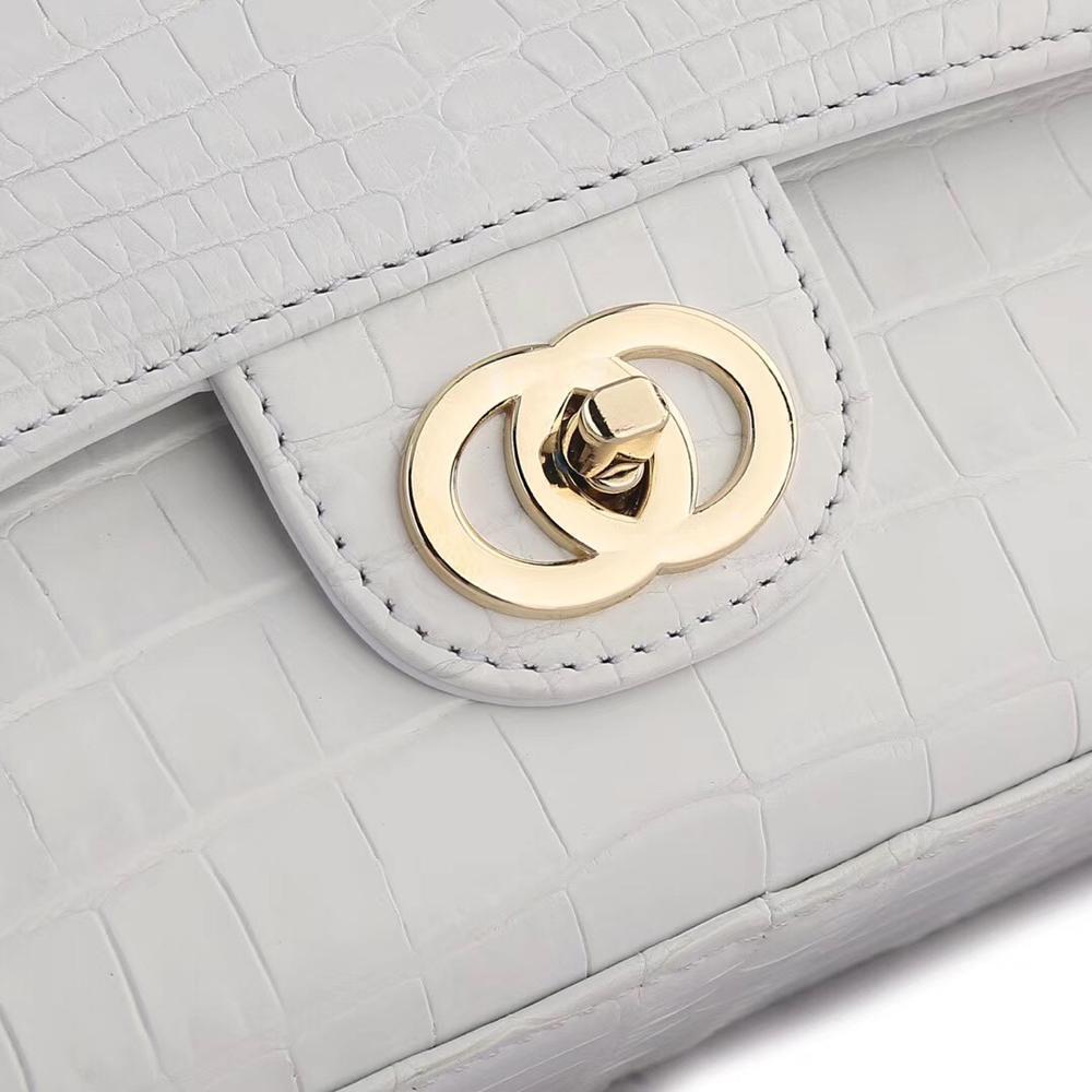 White crocodile leather shoulder handbag with classic flap and chain strap by Rossie Viren.