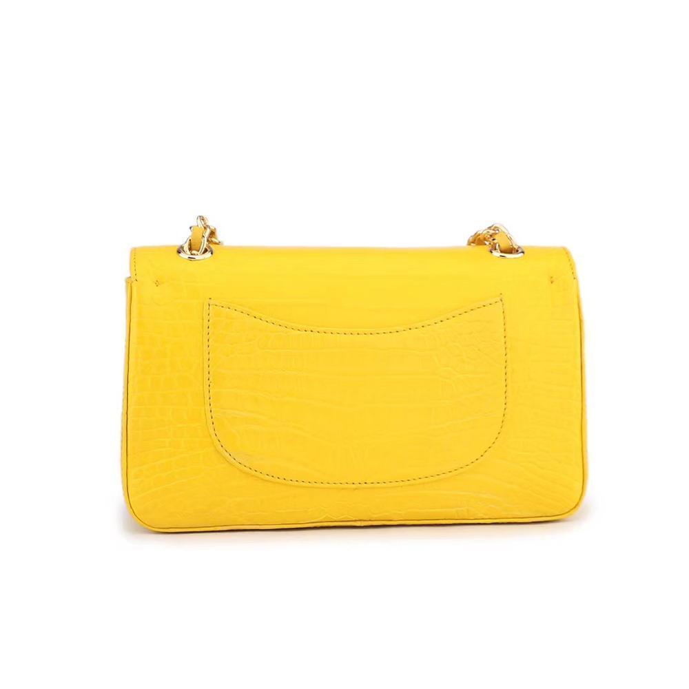 Yellow crocodile leather handbag with a classic flap and chain shoulder strap by Rossie Viren.