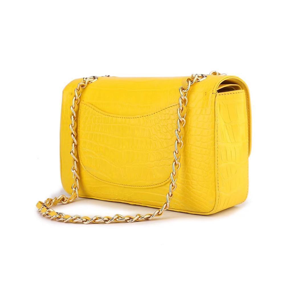 Yellow crocodile leather shoulder handbag with classic flap and chain strap by Rossie Viren for women.