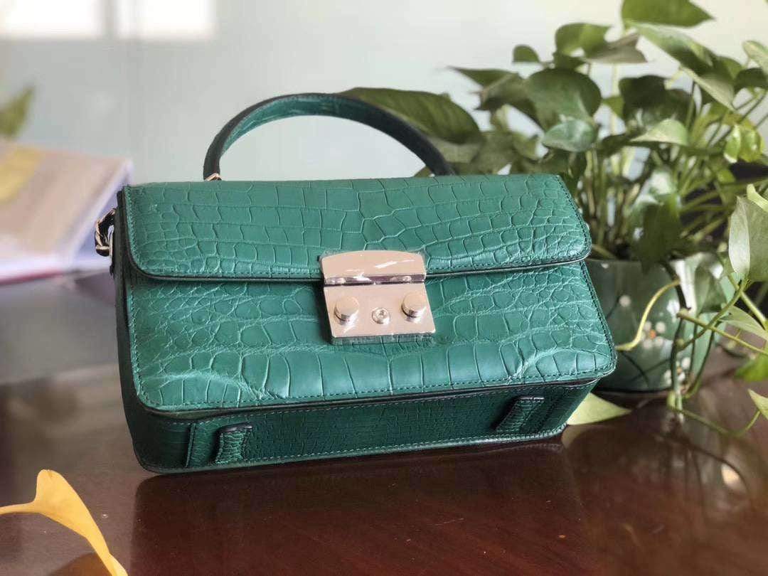 Rossie Viren crocodile leather cross body messenger handbag with top handle and sleek design.