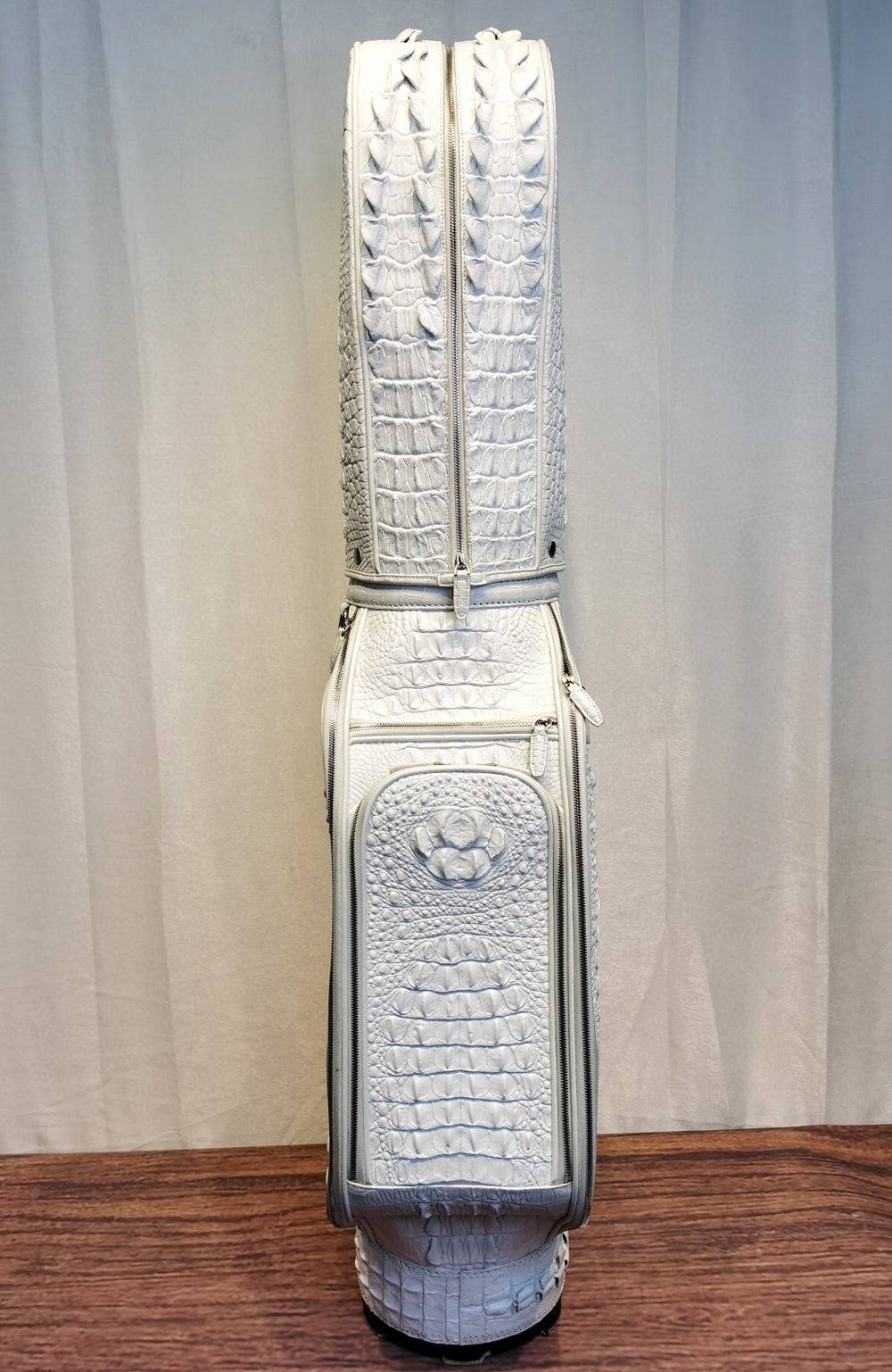 White crocodile leather golf bags by Rossie Viren, including golf sets, cart bags, and stand bags with luxurious textured design.