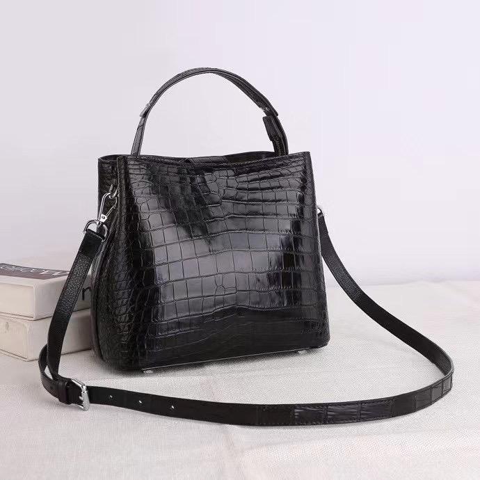 Crocodile leather hobo shoulder bag by Rossie Viren with barrel crossbody design and spacious interior.