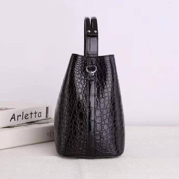 Crocodile leather hobo shoulder bag with barrel shape and crossbody strap by Rossie Viren, featuring textured crocodile pattern.