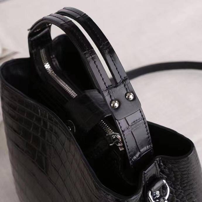Crocodile leather hobo shoulder bag by Rossie Viren featuring a barrel crossbody design with a textured finish.