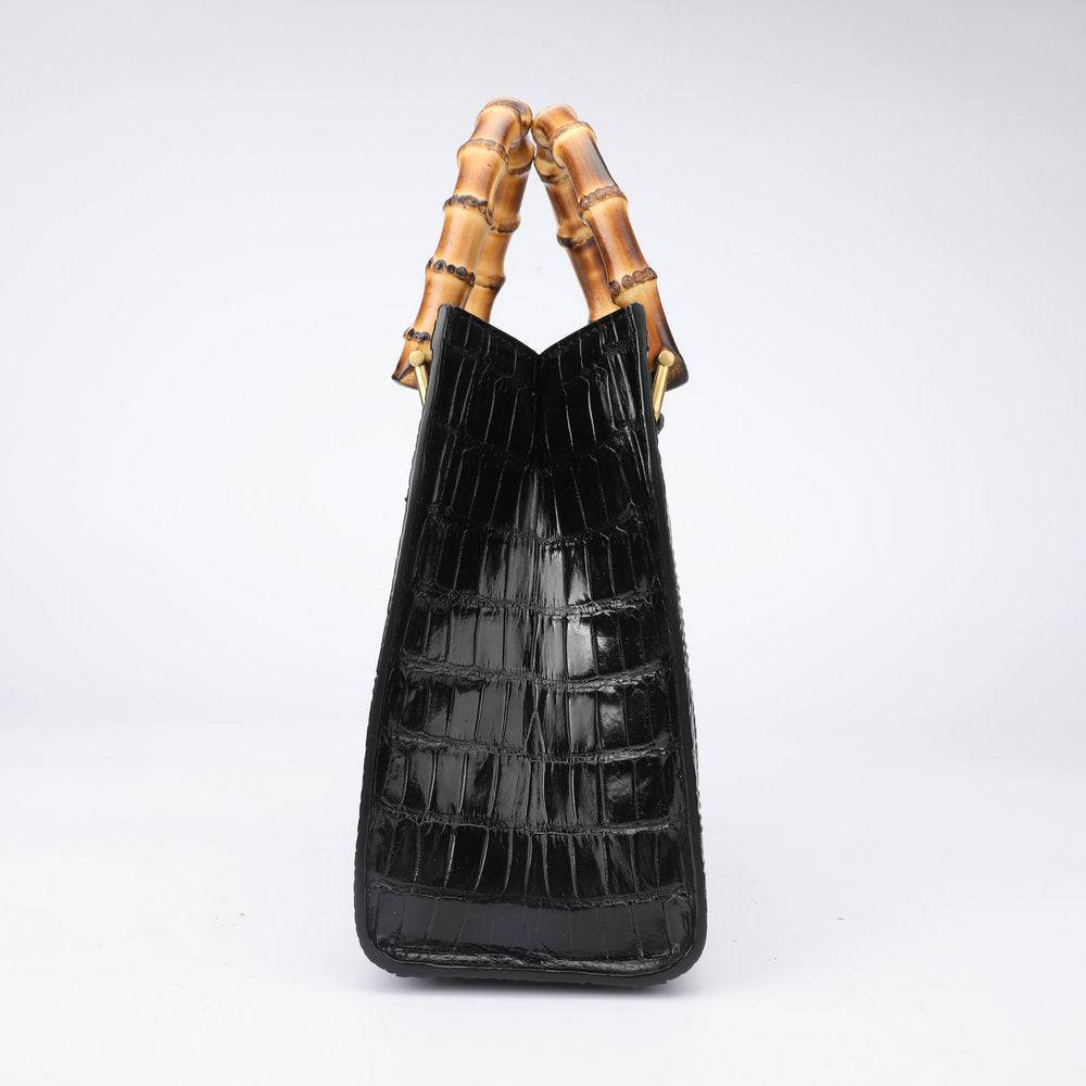 Rossie Viren crocodile leather micro top handle cross body handbag with a sleek, structured design and adjustable strap.