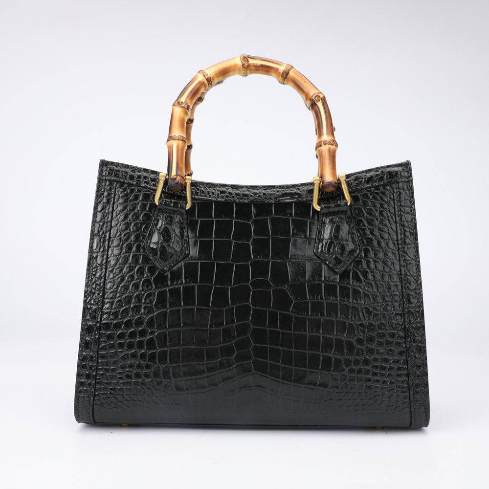 Rossie Viren crocodile leather micro top handle crossbody bag with large top handle and compact design.