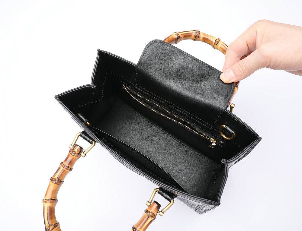 Rossie Viren crocodile leather handbag with a large top handle and crossbody strap, featuring a sleek, textured finish.