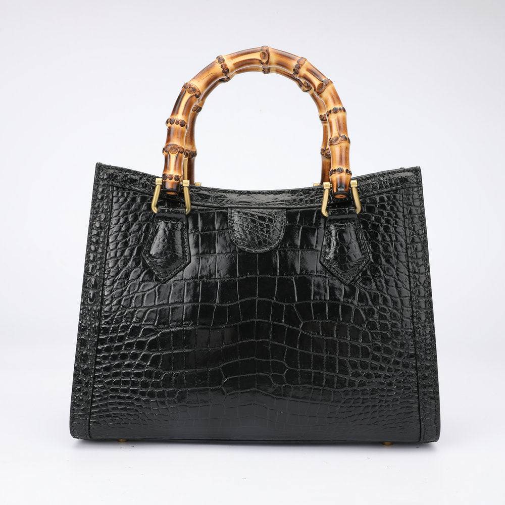 Crocodile leather micro top handle crossbody bag by Rossie Viren, featuring a sleek design and large top handle.