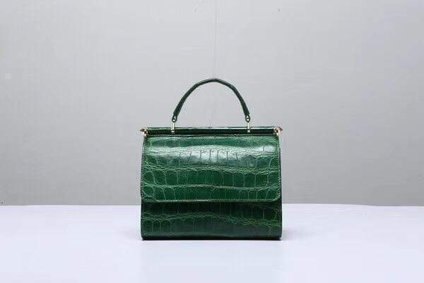 Dark green crocodile leather handbag with top handle from Rossie Viren, featuring a sleek, structured design and elegant craftsmanship.