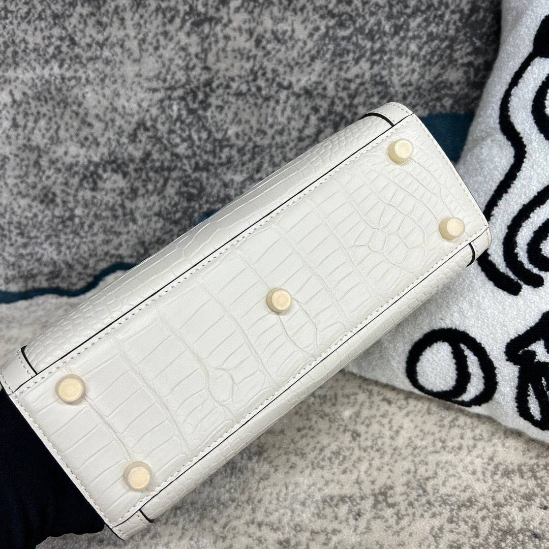 White crocodile skin leather shoulder crossbody bag with bamboo handle by Rossie Viren, stylish and elegant handbag.