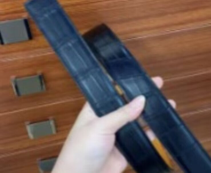 Dark blue crocodile skin leather belt by Rossie Viren, featuring a textured crocodile pattern and polished buckle.