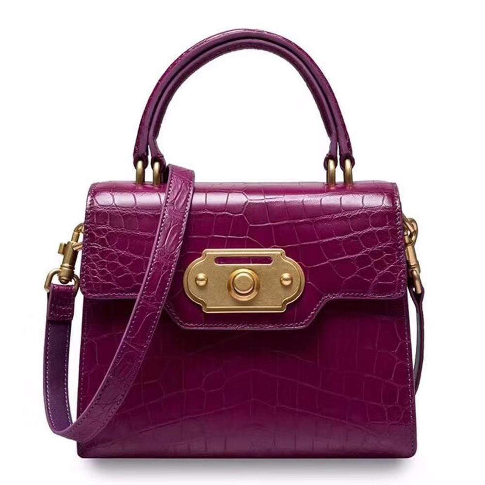 Genuine crocodile belly leather top handle shoulder purse by Rossie Viren with sleek design and polished finish.