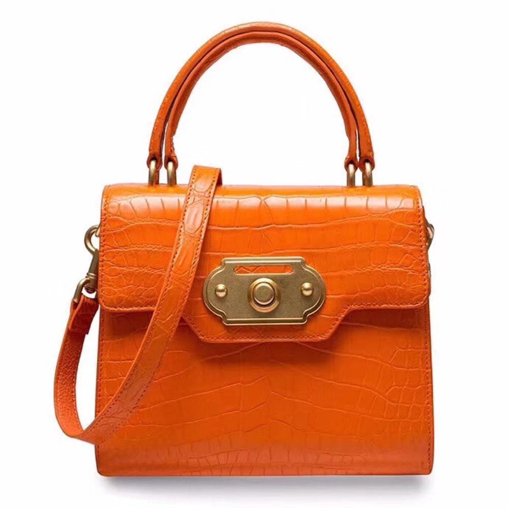 Rossie Viren genuine crocodile belly leather handbag with top handle and shoulder strap, featuring a sleek, luxurious design.
