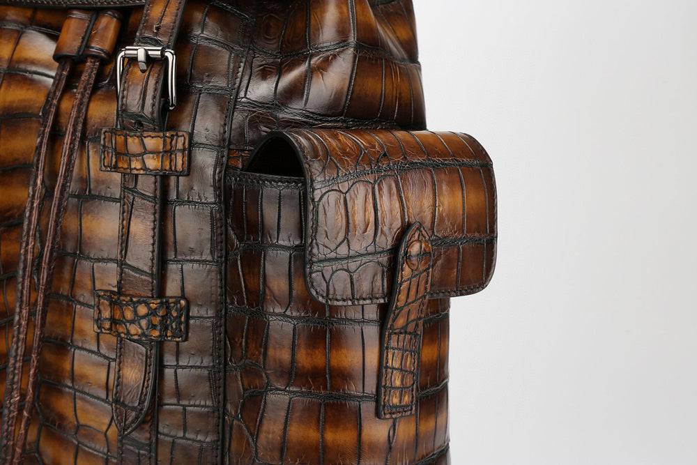 Genuine crocodile leather handbag by Rossie Viren featuring a structured design and top handle, showcasing luxurious texture.