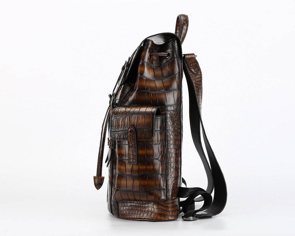 Genuine crocodile leather handbag by Rossie Viren featuring a structured design with adjustable straps and silver hardware.