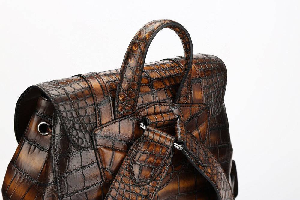 Genuine crocodile leather handbag by Rossie Viren, featuring a sleek design with textured crocodile pattern and sturdy leather straps.